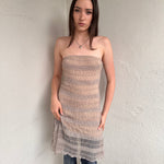 Woman wearing a Y2K 00s Beige mesh strapless dress features a textured, semi-sheer design that channels effortless festival vibes. 