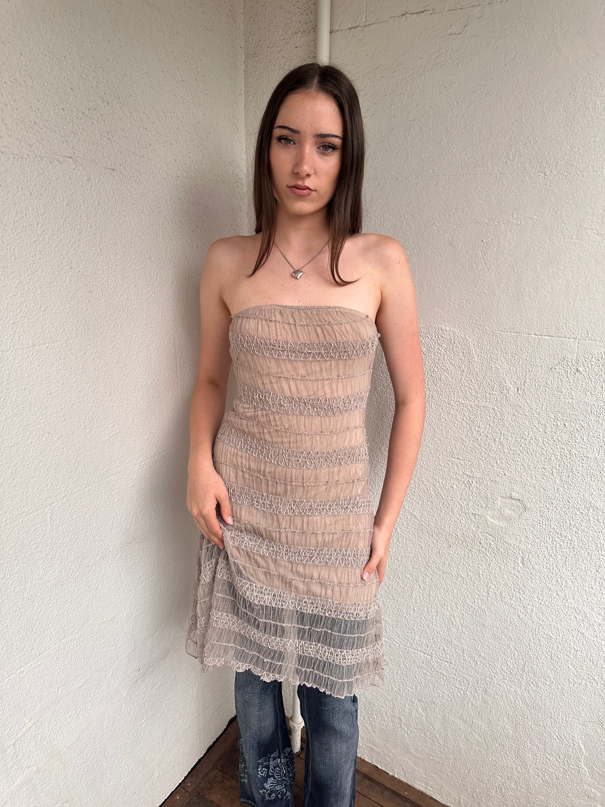 Woman wearing a Y2K 00s Beige mesh strapless dress features a textured, semi-sheer design that channels effortless festival vibes. 