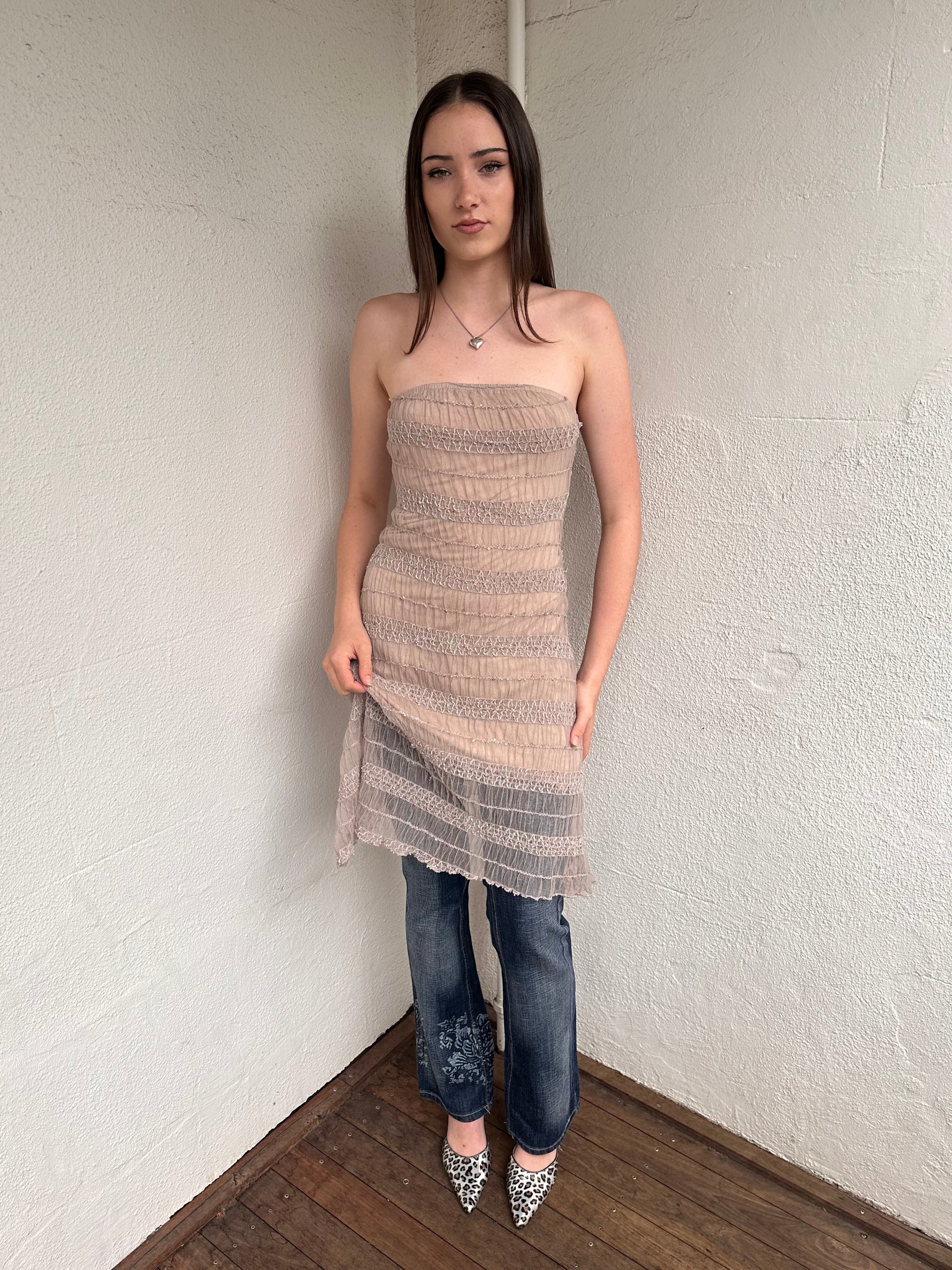 Woman wearing a Y2K 00s Beige mesh strapless dress features a textured, semi-sheer design that channels effortless festival vibes. 