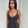 Woman Dressed in Y2K 00s Black animal print mesh cami top with a fitted silhouette, slight padding in the cups, and a soft stretch fabric.