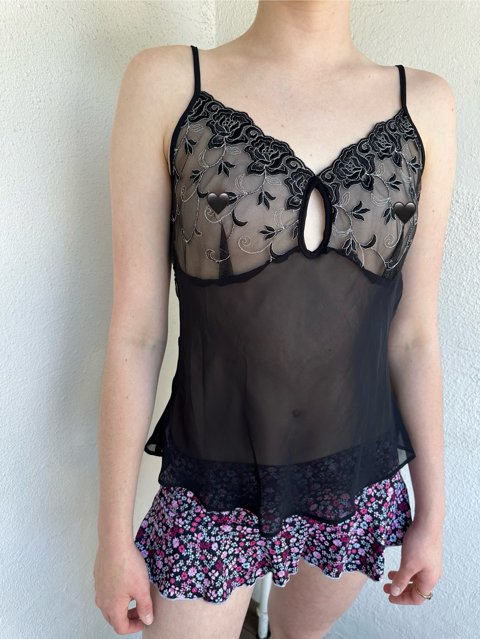 Woman Dressed in Y2K Black embroidered mesh cami top featuring a sheer bust with black and silver floral embroidery. 