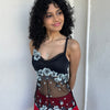Woman wearing a Y2K 00s Black with white floral embroidery mesh cami top. Light blue floral embroidery featured 