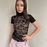 Women wearing a 00s Y2K Black floral sheer mesh turtleneck t-shirt featuring an all-over delicate floral pattern. 