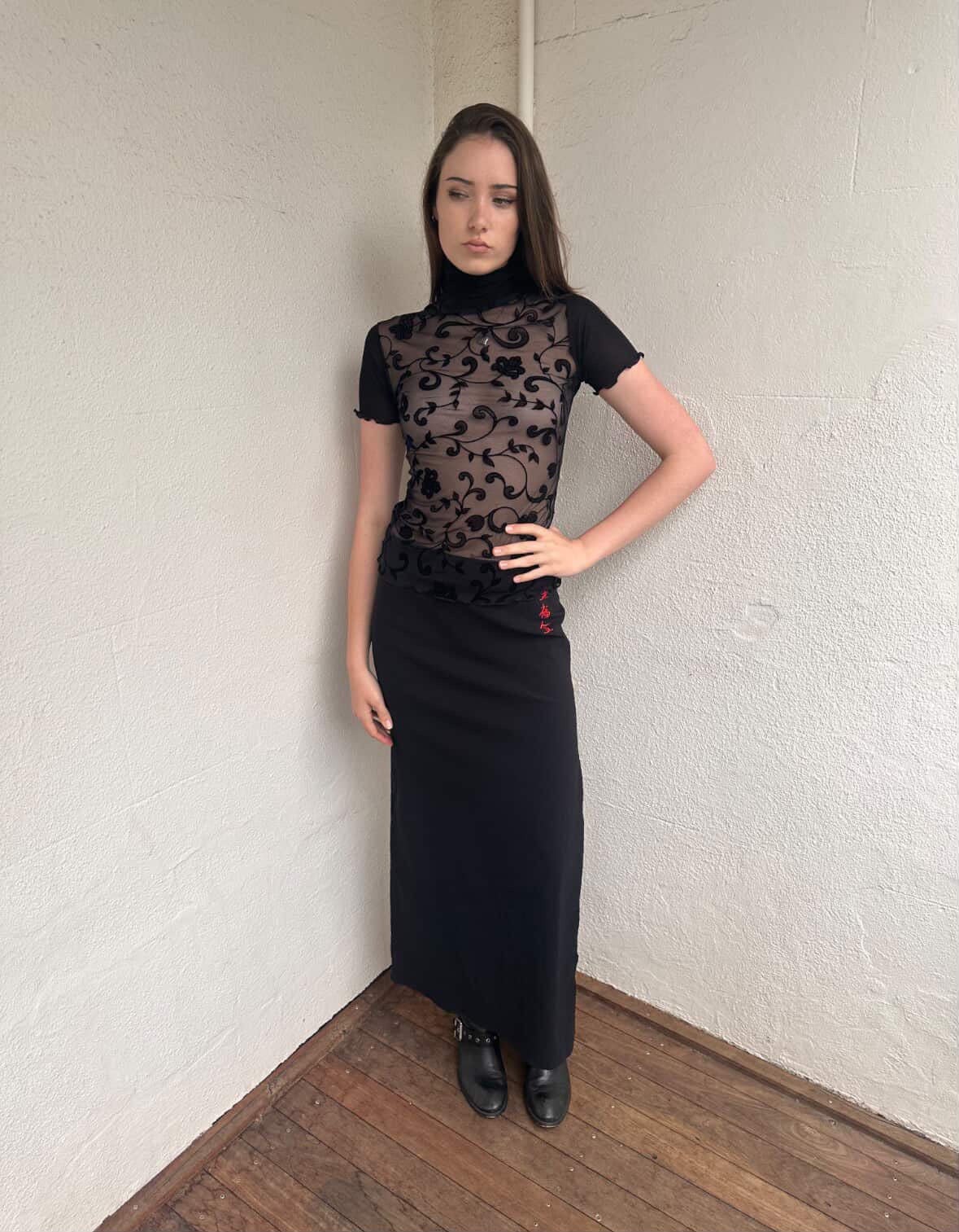 Women wearing a 00s Y2K Black floral sheer mesh turtleneck t-shirt featuring an all-over delicate floral pattern. 