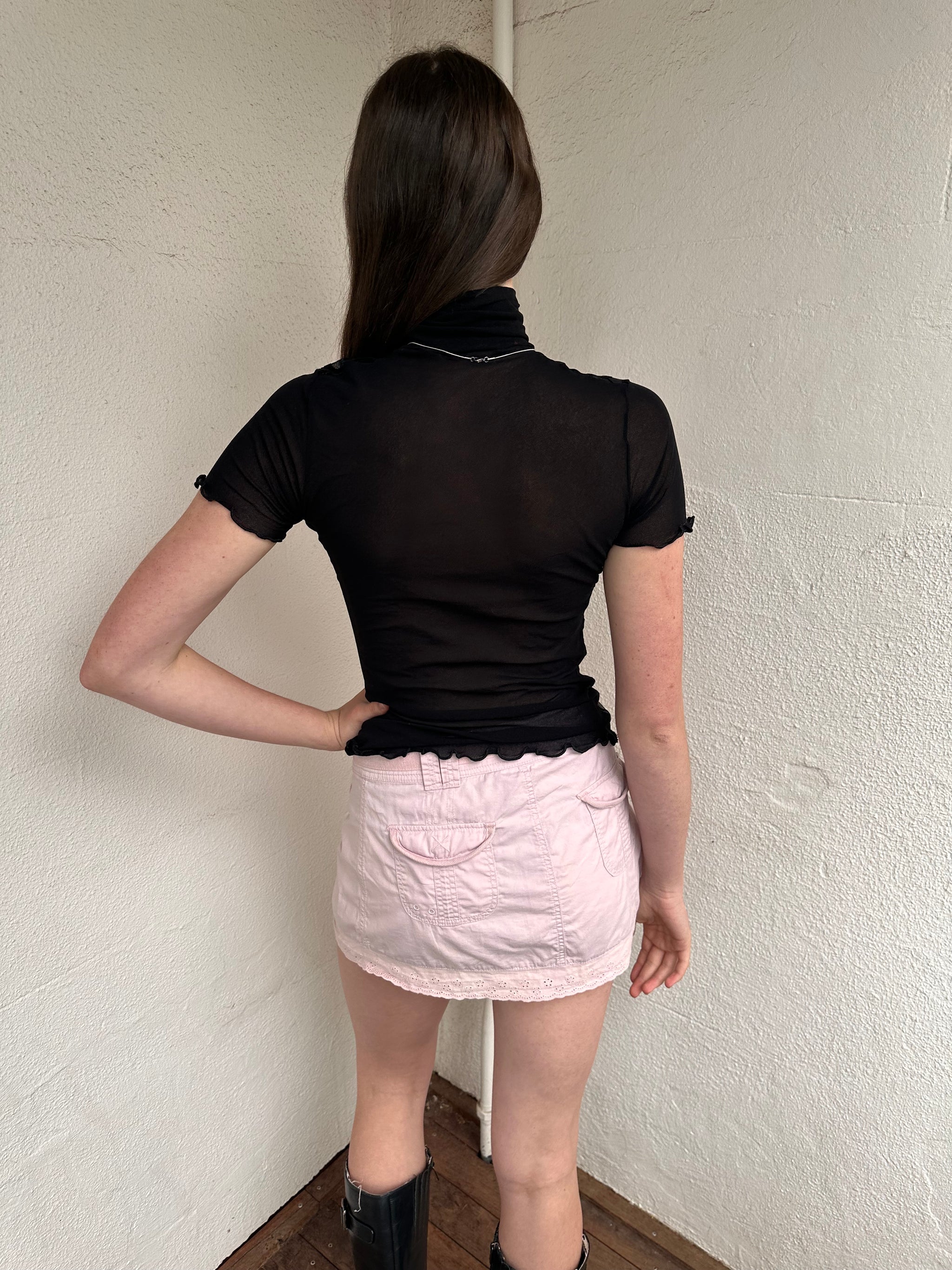 Women wearing a 00s Y2K Black floral sheer mesh turtleneck t-shirt featuring an all-over delicate floral pattern. 