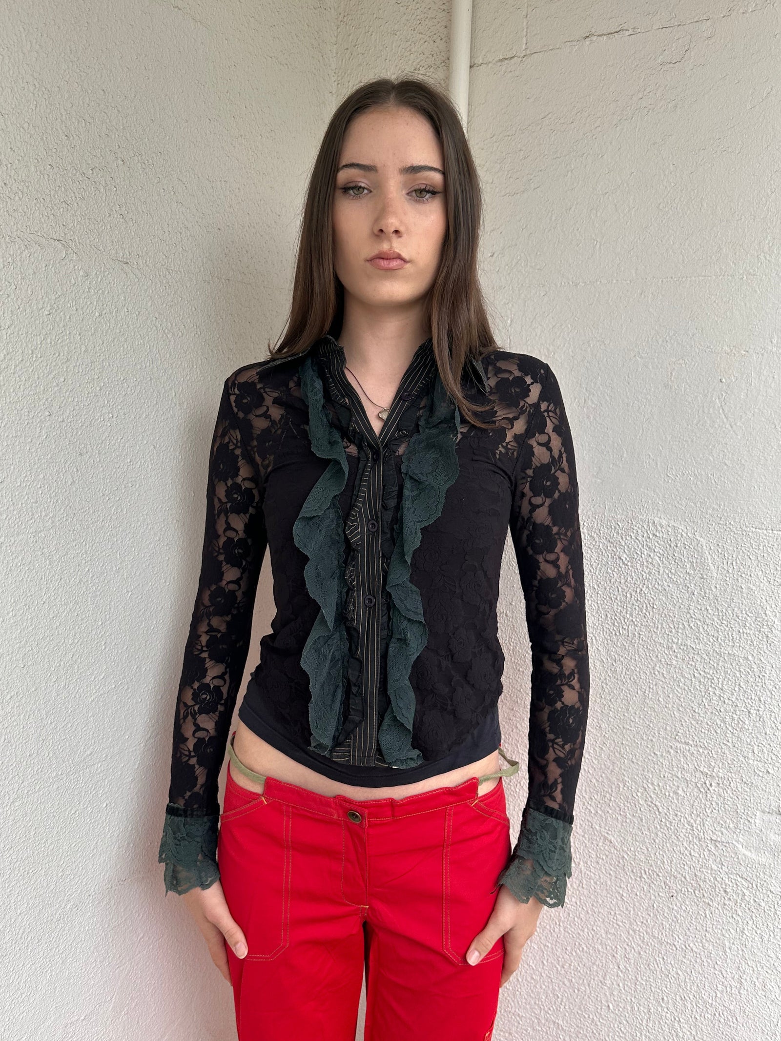 Women wearing a 00s Y2K Black and khaki lace long sleeve shirt with ruffled khaki lace along the front opening and cuffs. 