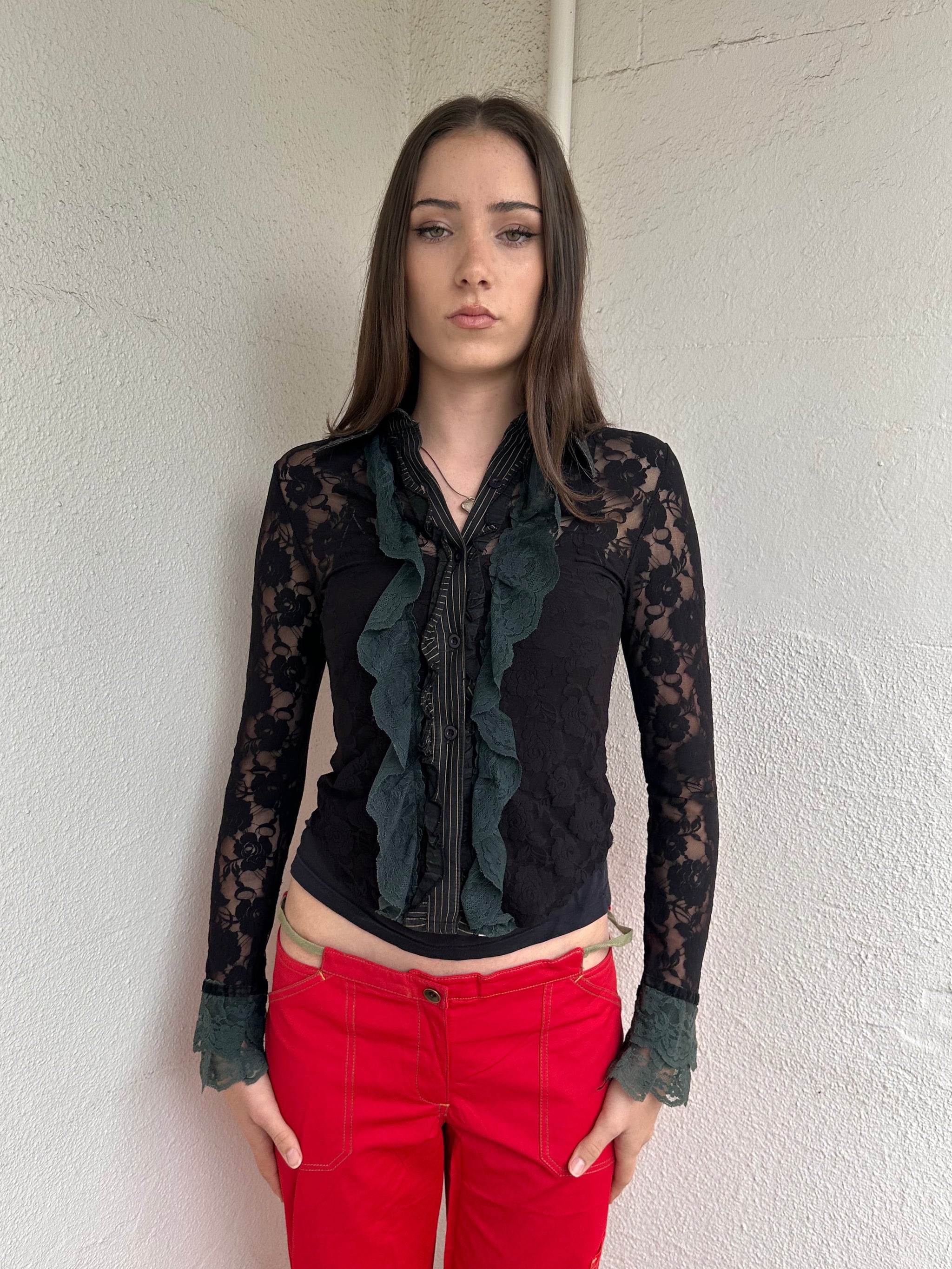 Women wearing a 00s Y2K Black and khaki lace long sleeve shirt with ruffled khaki lace along the front opening and cuffs. 