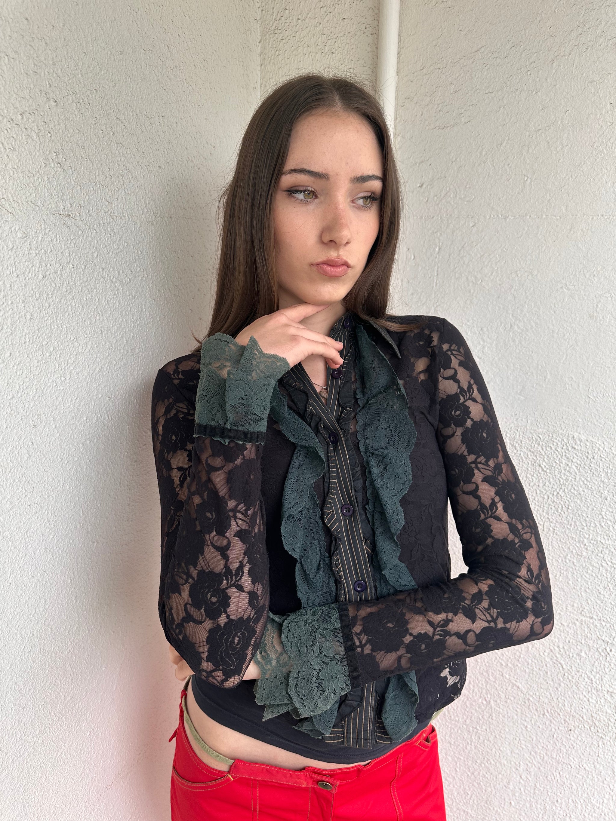 Women wearing a 00s Y2K Black and khaki lace long sleeve shirt with ruffled khaki lace along the front opening and cuffs. 