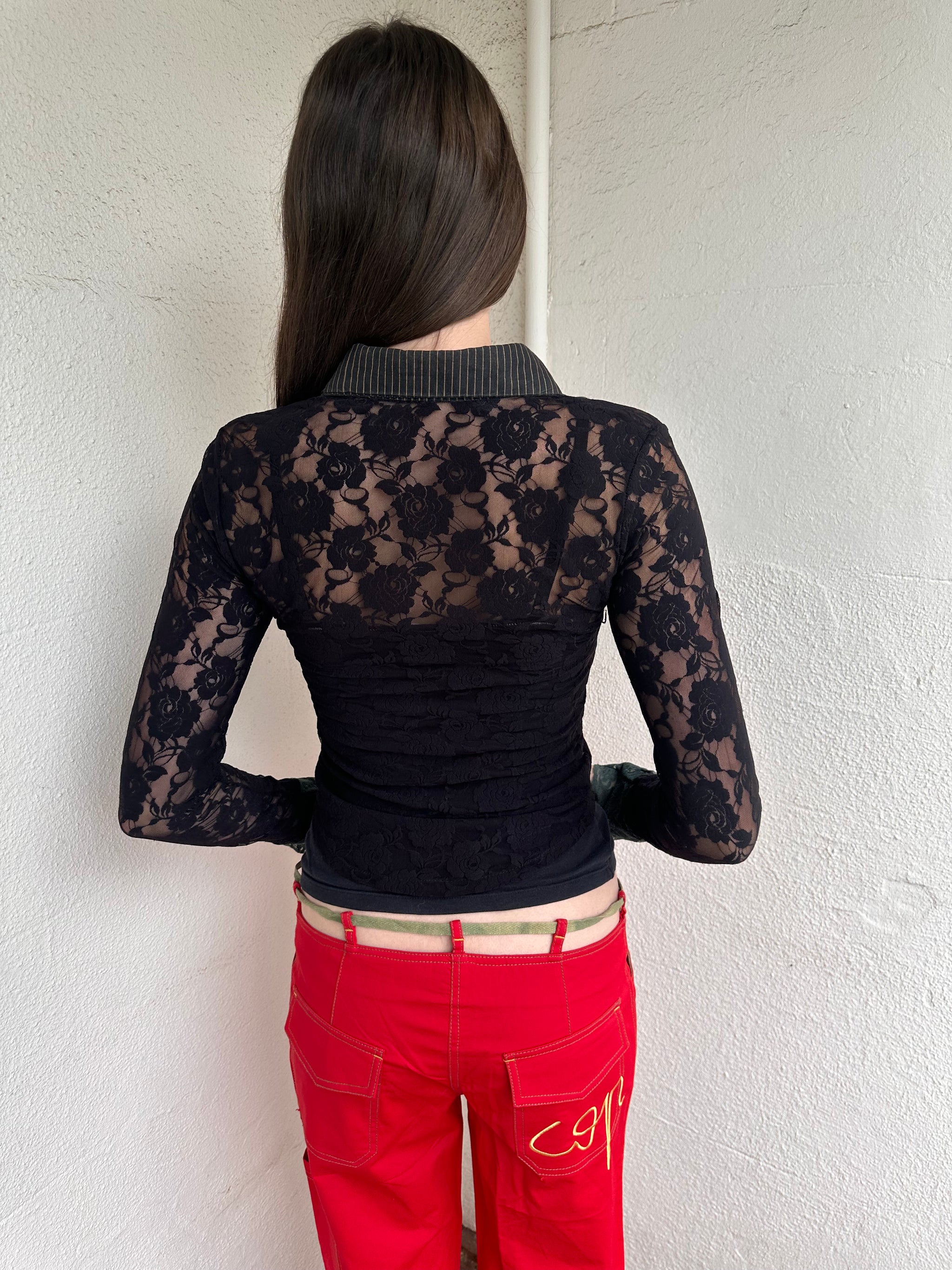 Women wearing a 00s Y2K Black and khaki lace long sleeve shirt with ruffled khaki lace along the front opening and cuffs. 