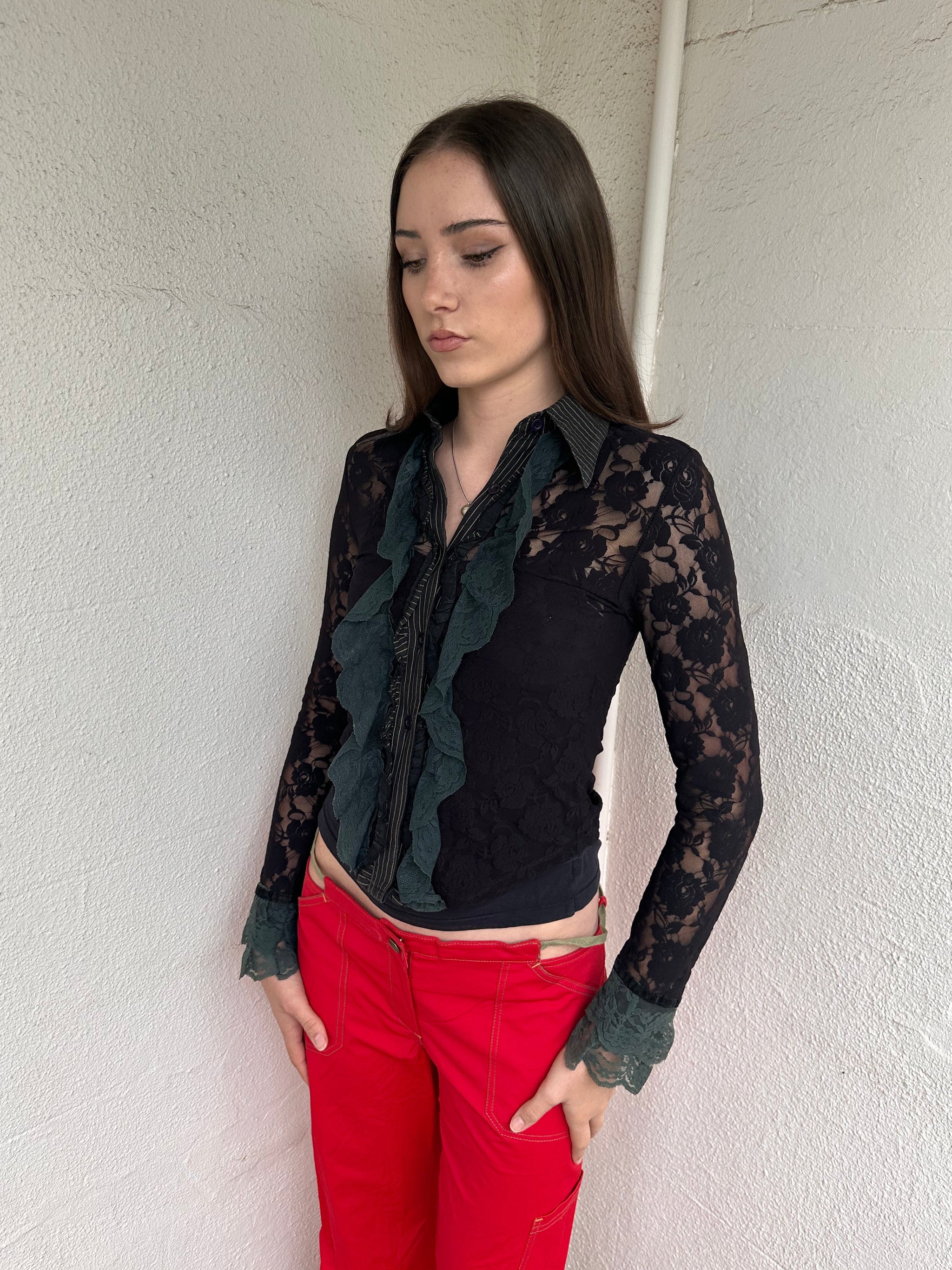 Women wearing a 00s Y2K Black and khaki lace long sleeve shirt with ruffled khaki lace along the front opening and cuffs. 
