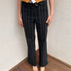 Women wearing a 00s Y2K Black and white pinstripe suit pants with a built-in grommet-look belt and straight-leg cut. 