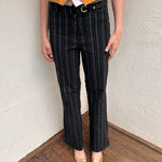 Women wearing a 00s Y2K Black and white pinstripe suit pants with a built-in grommet-look belt and straight-leg cut. 