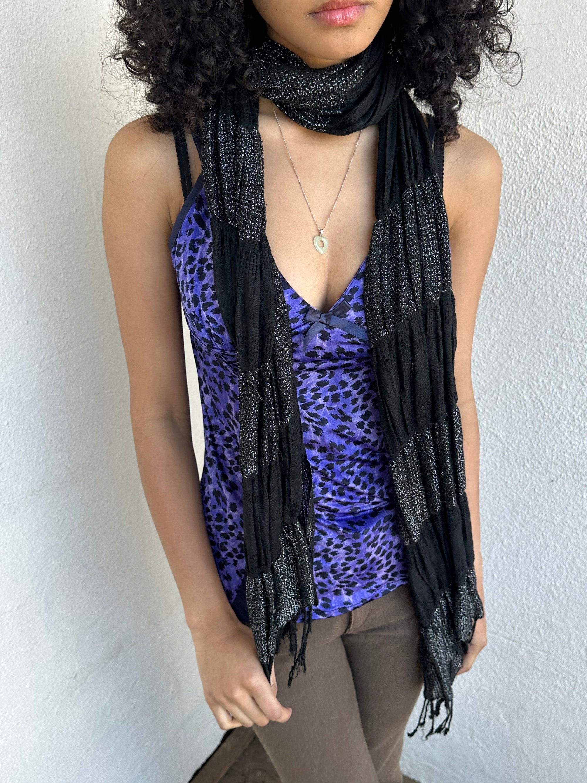 Woman wearing a Y2K 90s Black shimmer stripe scarf from the 00s.