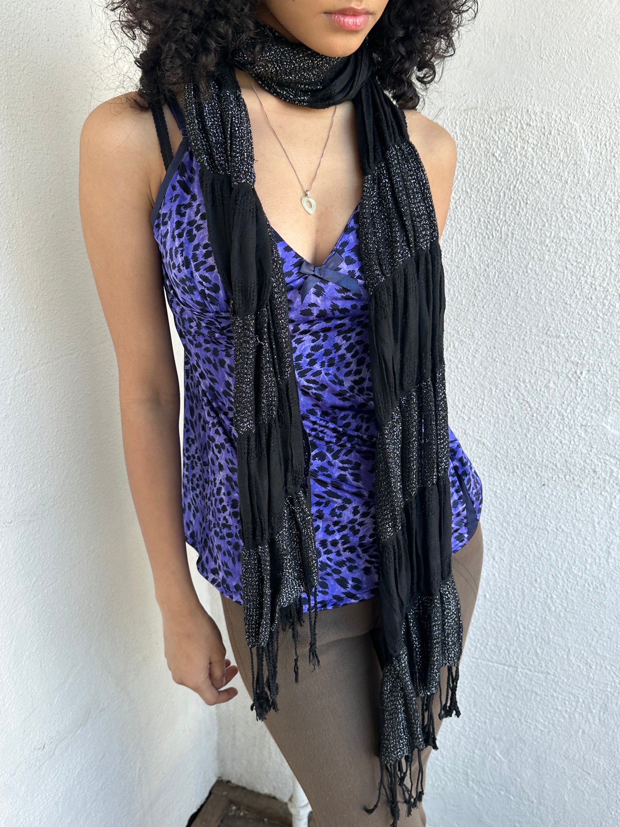 Woman wearing a Y2K 90s Black shimmer stripe scarf from the 00s.