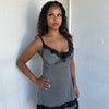 Woman Dressed in Y2K 00s Black and white checkered mini dress with a fitted bodice and flattering mini-length silhouette.