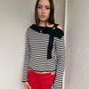Women wearing a 00s Y2K lack and white stripe knitted top with an asymmetric collar and one-shoulder strap.
