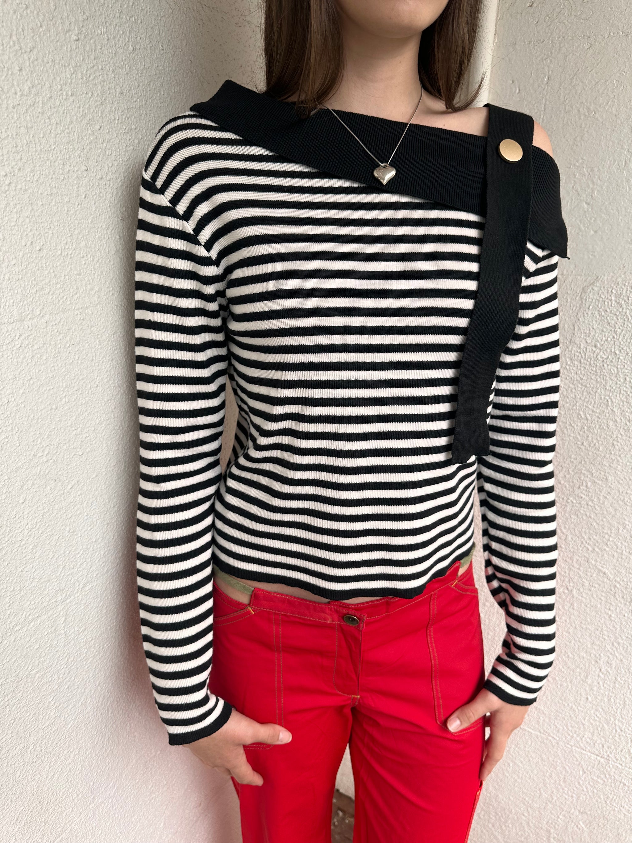 Women wearing a 00s Y2K lack and white stripe knitted top with an asymmetric collar and one-shoulder strap.