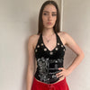 Woman wearing a Y2K 00s black grunge silver and white text graphic style halter top 