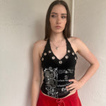 Woman wearing a Y2K 00s black grunge silver and white text graphic style halter top 