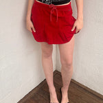 Woman wearing a Y2K 00s black grunge silver and white text graphic style halter top 