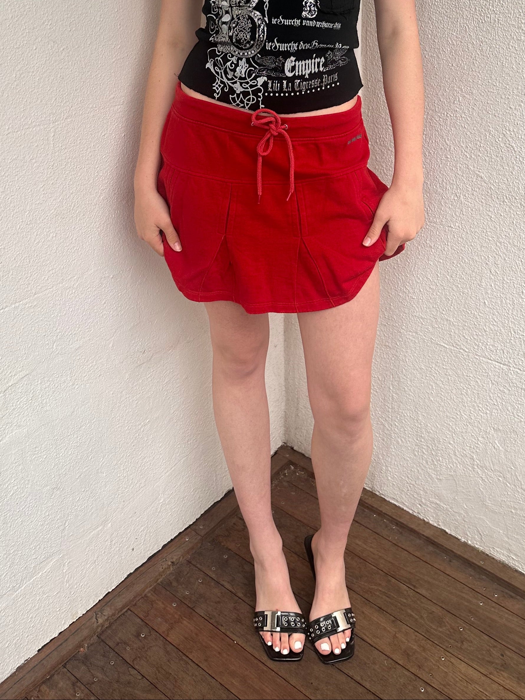 Woman wearing a Y2K 00s black grunge silver and white text graphic style halter top 