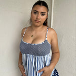 Woman Dressed in Y2K 00s Blue floral and stripe cami featuring a white and blue/navy floral bust with a striped base