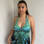 Woman Dressed in Y2K Blue and green Y2K patterned halter top featuring a bold abstract pattern