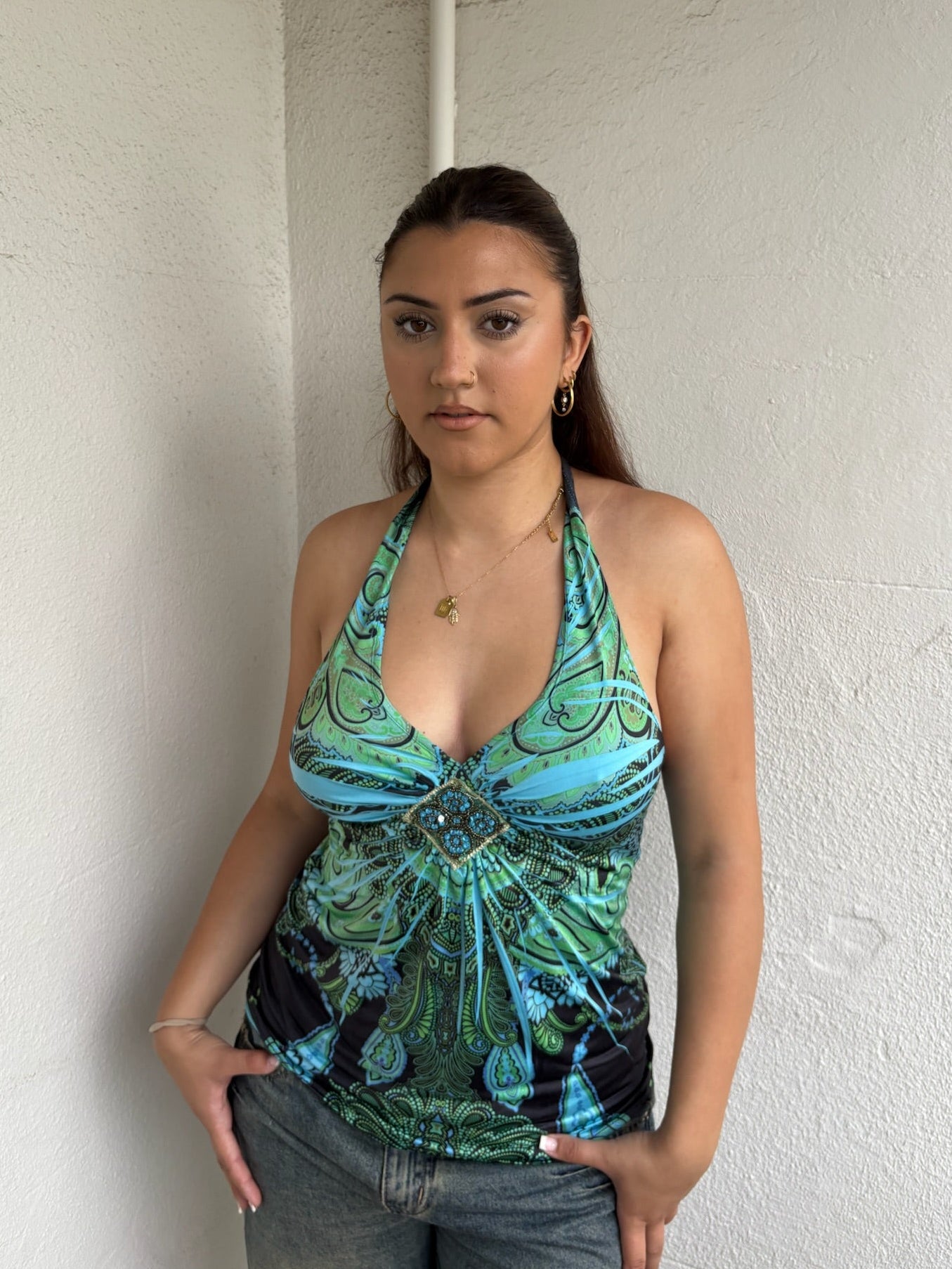 Woman Dressed in Y2K Blue and green Y2K patterned halter top featuring a bold abstract pattern