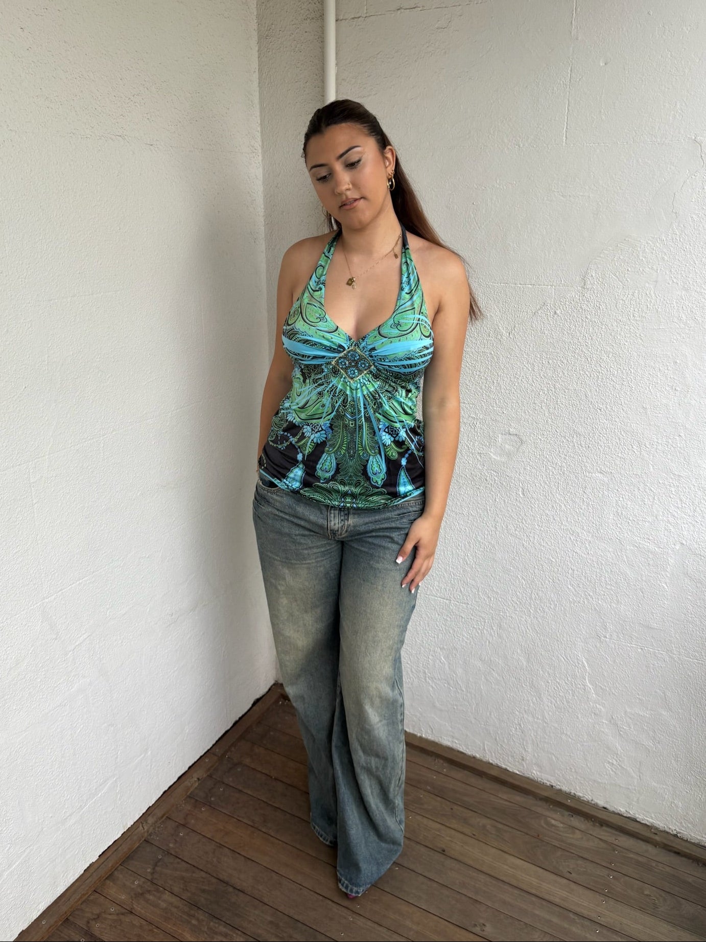 Woman Dressed in Y2K Blue and green Y2K patterned halter top featuring a bold abstract pattern