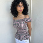 Woman wearing a Y2K 00s inspired reworked milkmaid off the shoulder top 