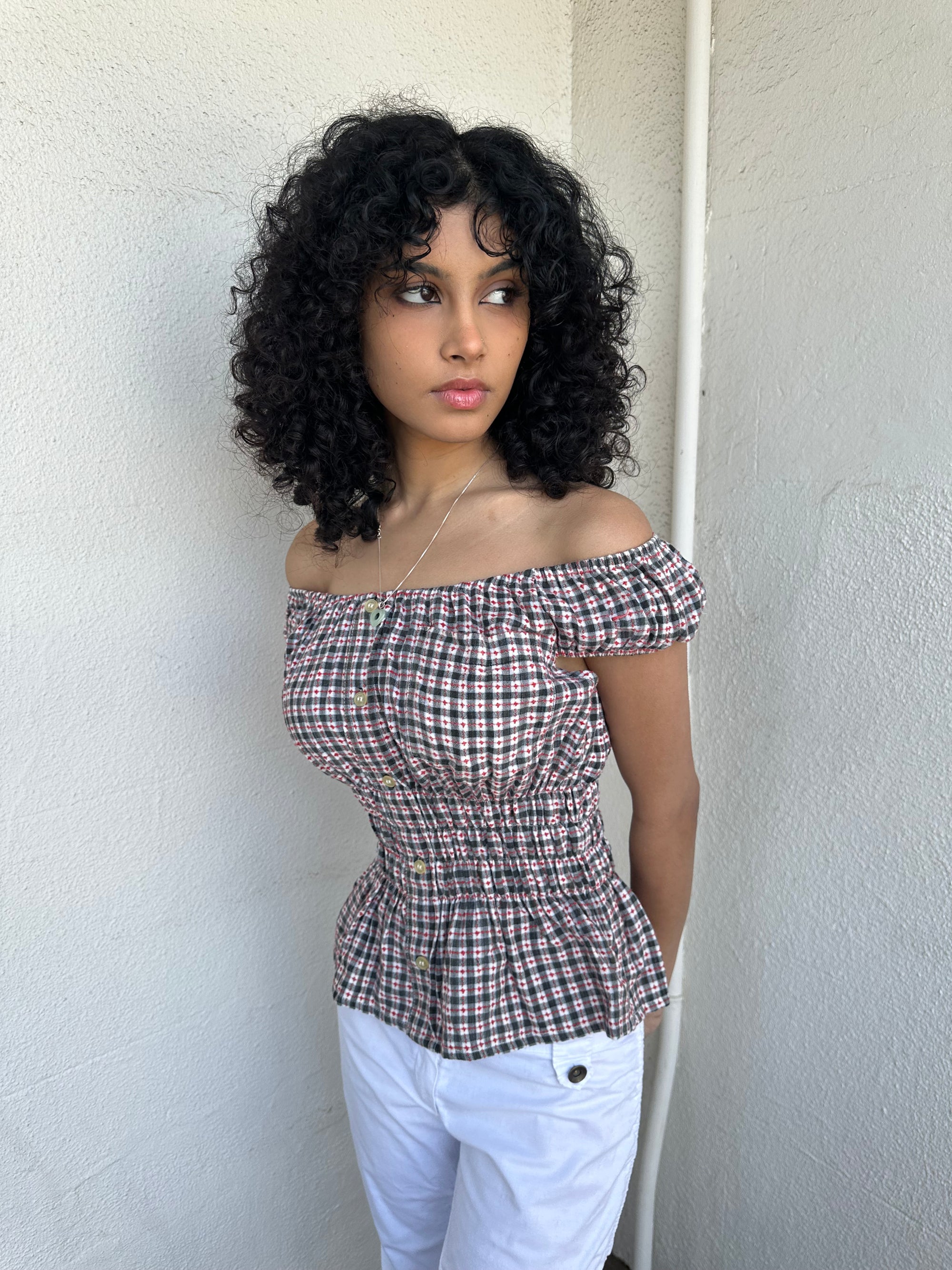 Woman wearing a Y2K 00s inspired reworked milkmaid off the shoulder top 