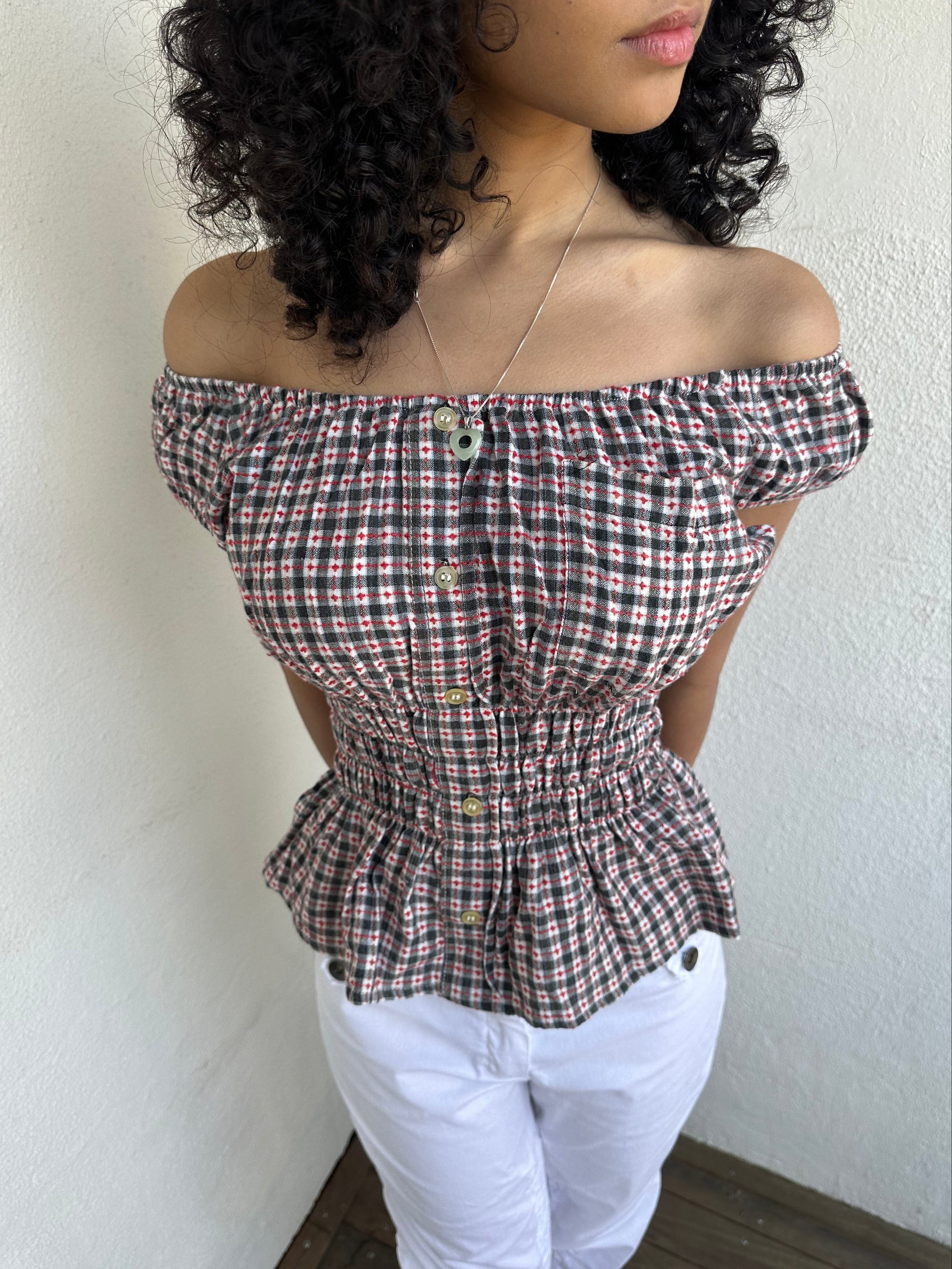 Woman wearing a Y2K 00s inspired reworked milkmaid off the shoulder top 