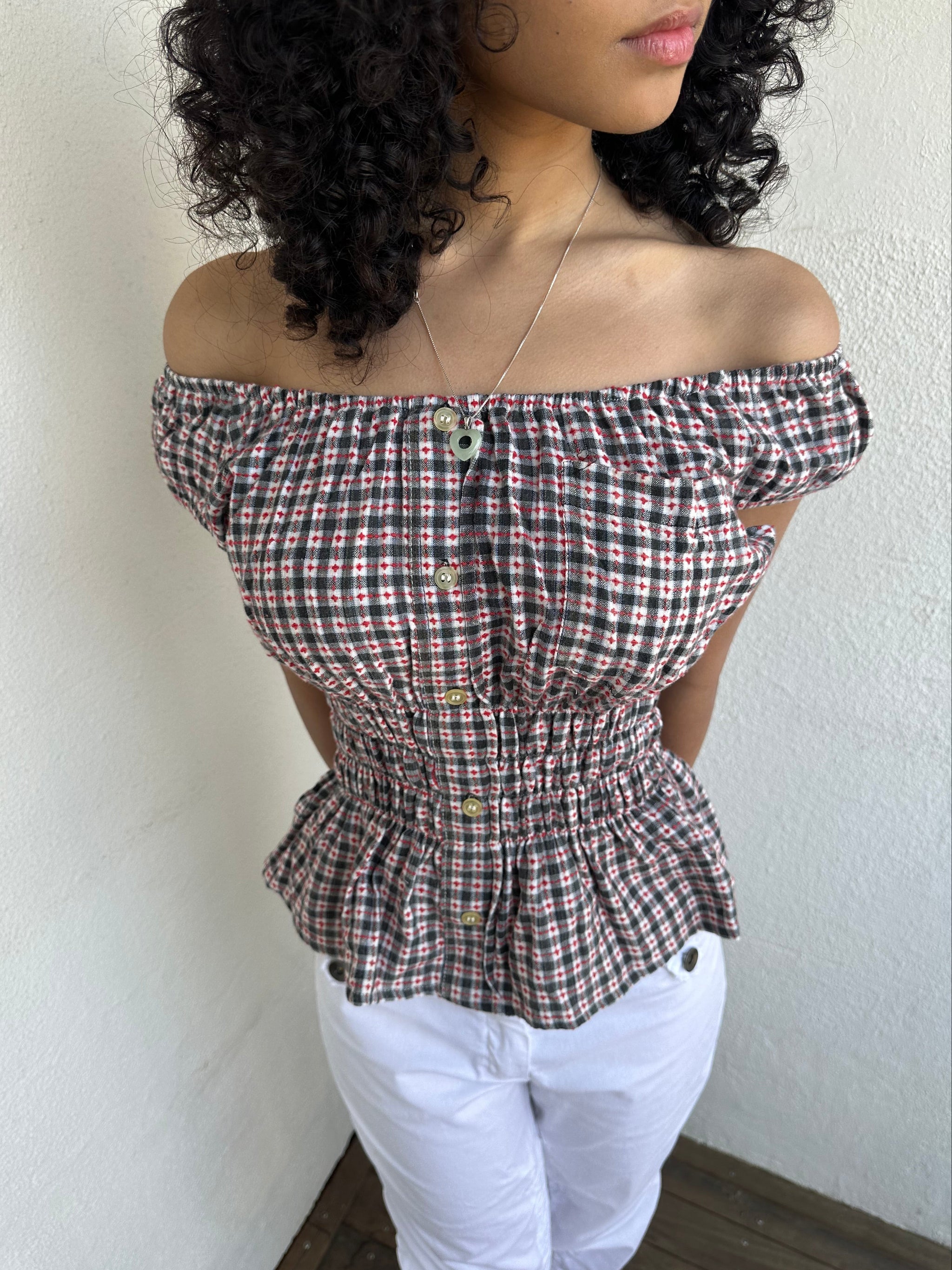 Woman wearing a Y2K 00s inspired reworked milkmaid off the shoulder top 