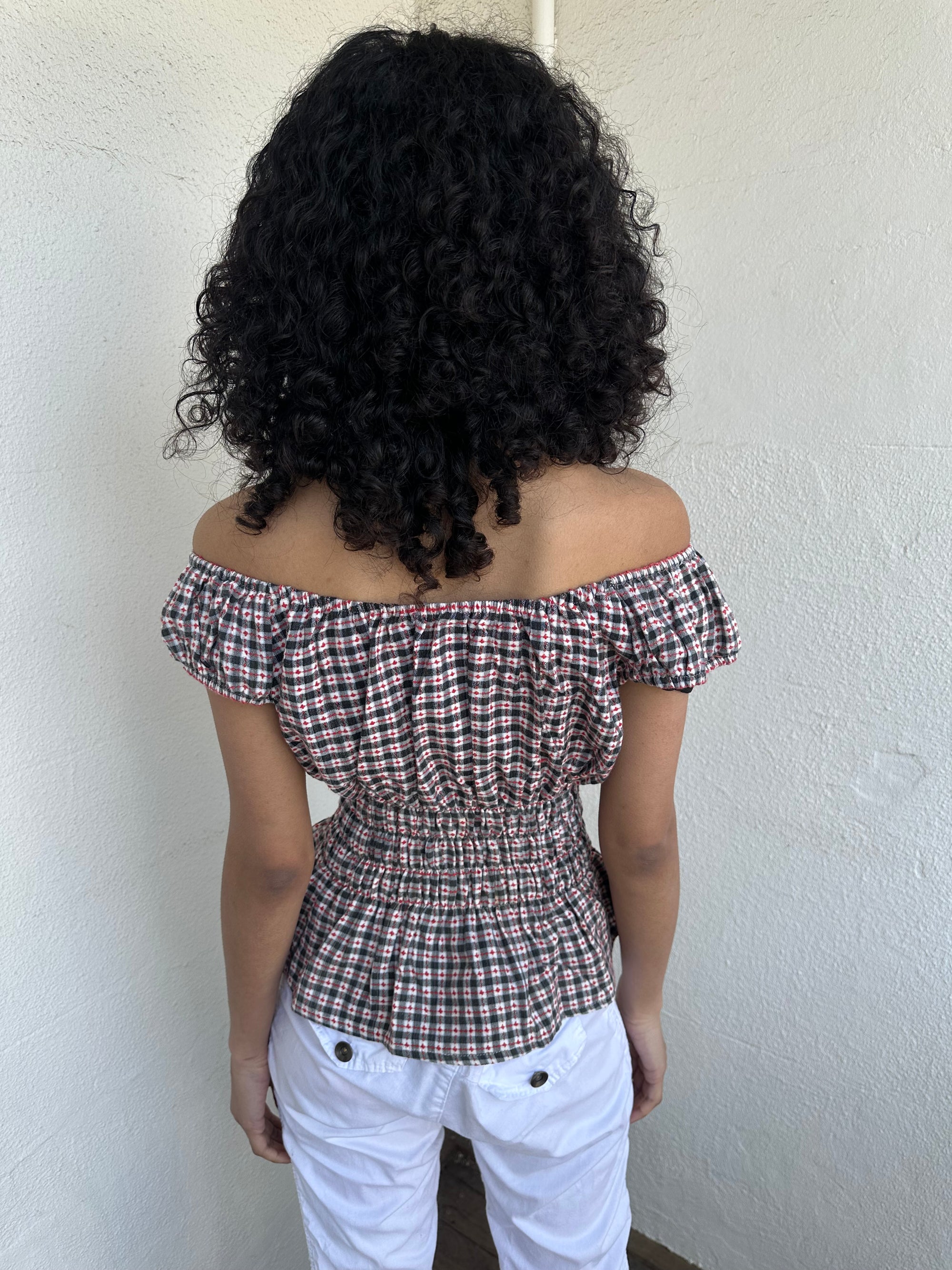 Woman wearing a Y2K 00s inspired reworked milkmaid off the shoulder top 