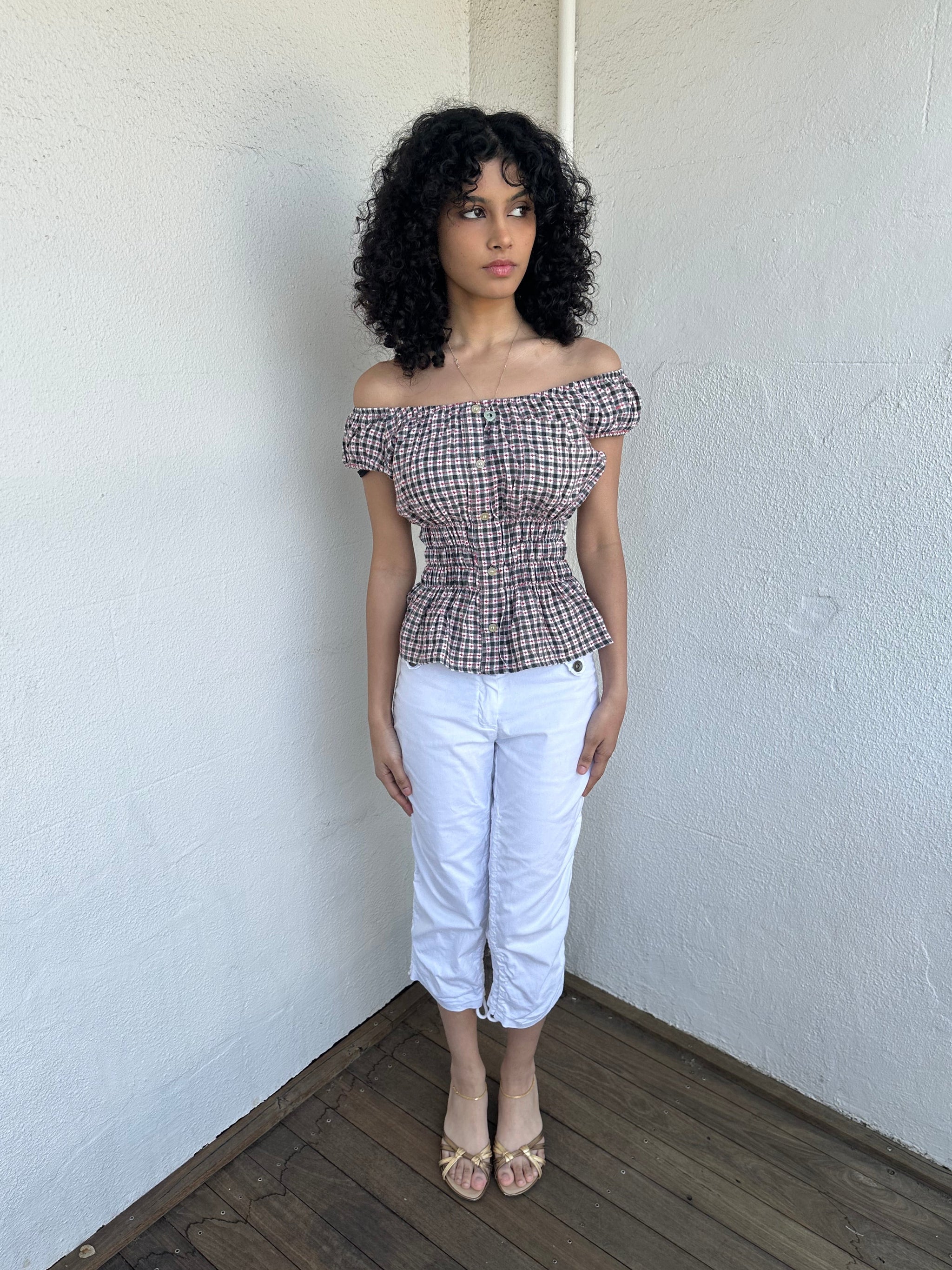 Woman wearing a Y2K 00s inspired reworked milkmaid off the shoulder top 