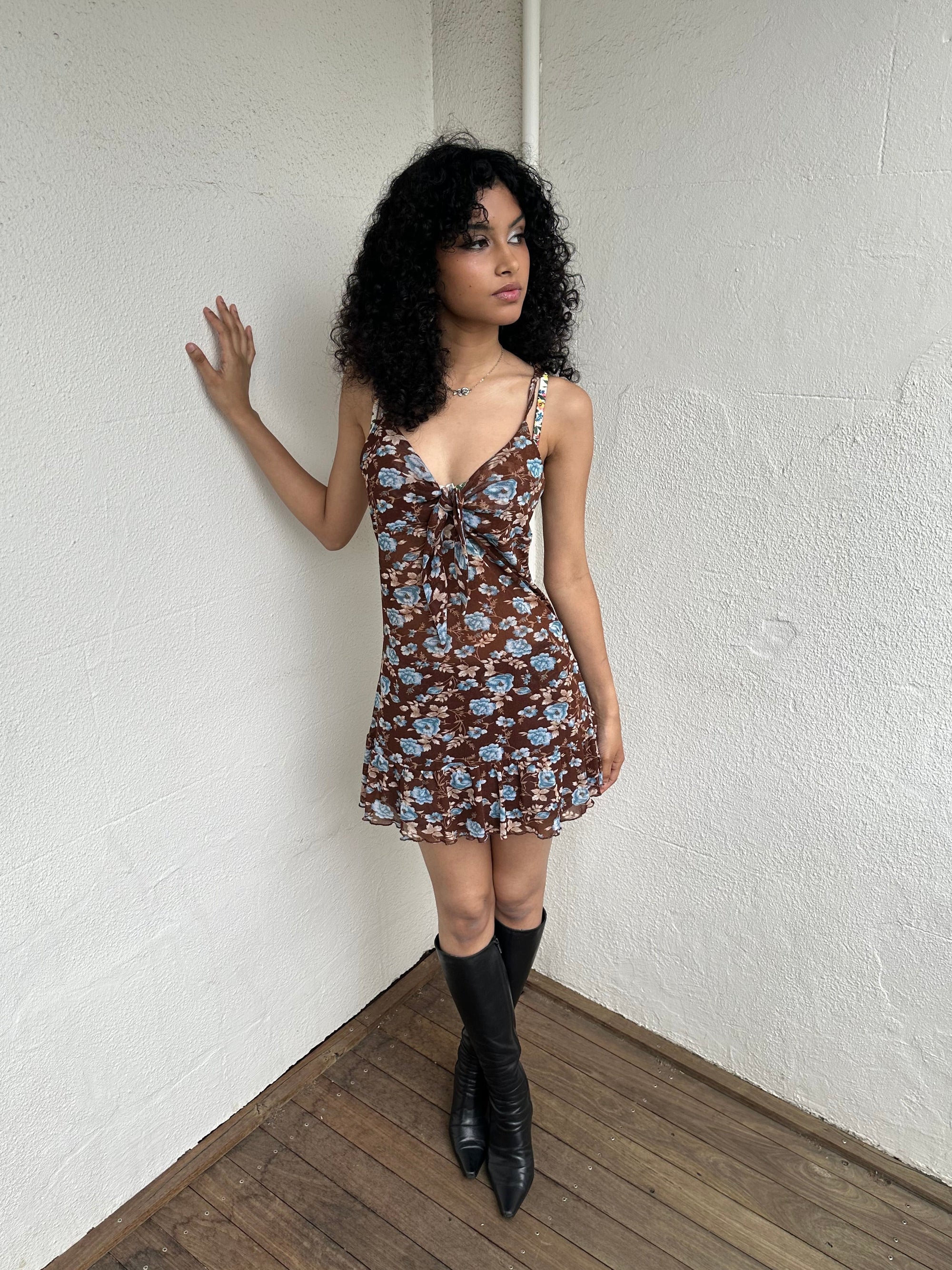 Woman Dressed in Y2K 00s Y2K Brown and blue floral mesh mini dress featuring a soft floral print in brown and blue tones throughout.