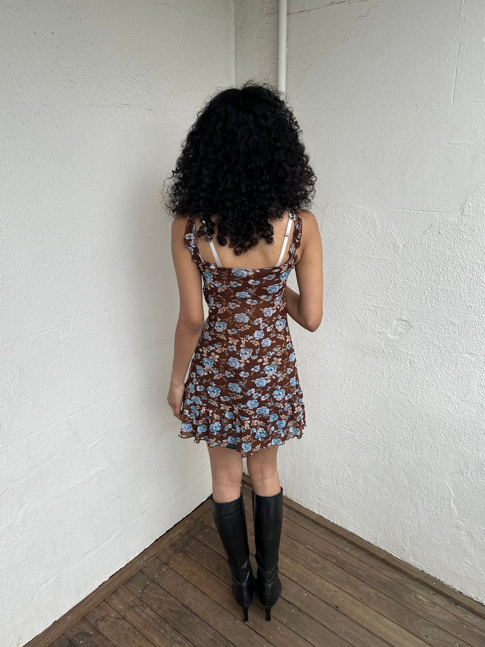 Woman Dressed in Y2K 00s Y2K Brown and blue floral mesh mini dress featuring a soft floral print in brown and blue tones throughout.