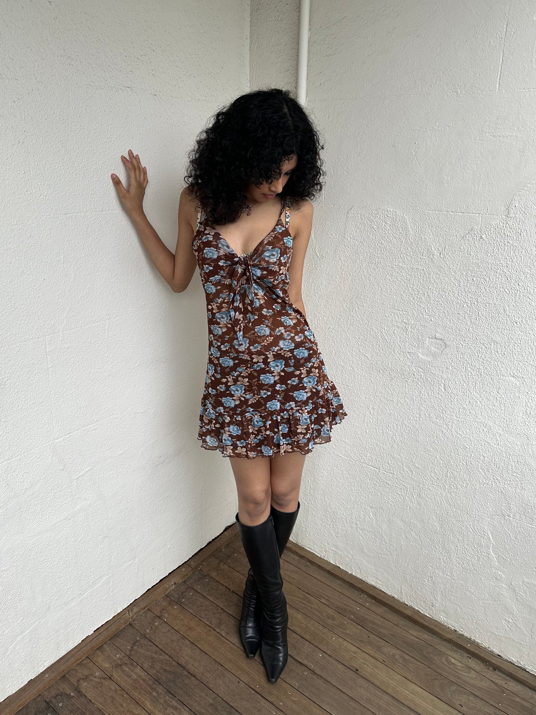 Woman Dressed in Y2K 00s Y2K Brown and blue floral mesh mini dress featuring a soft floral print in brown and blue tones throughout.