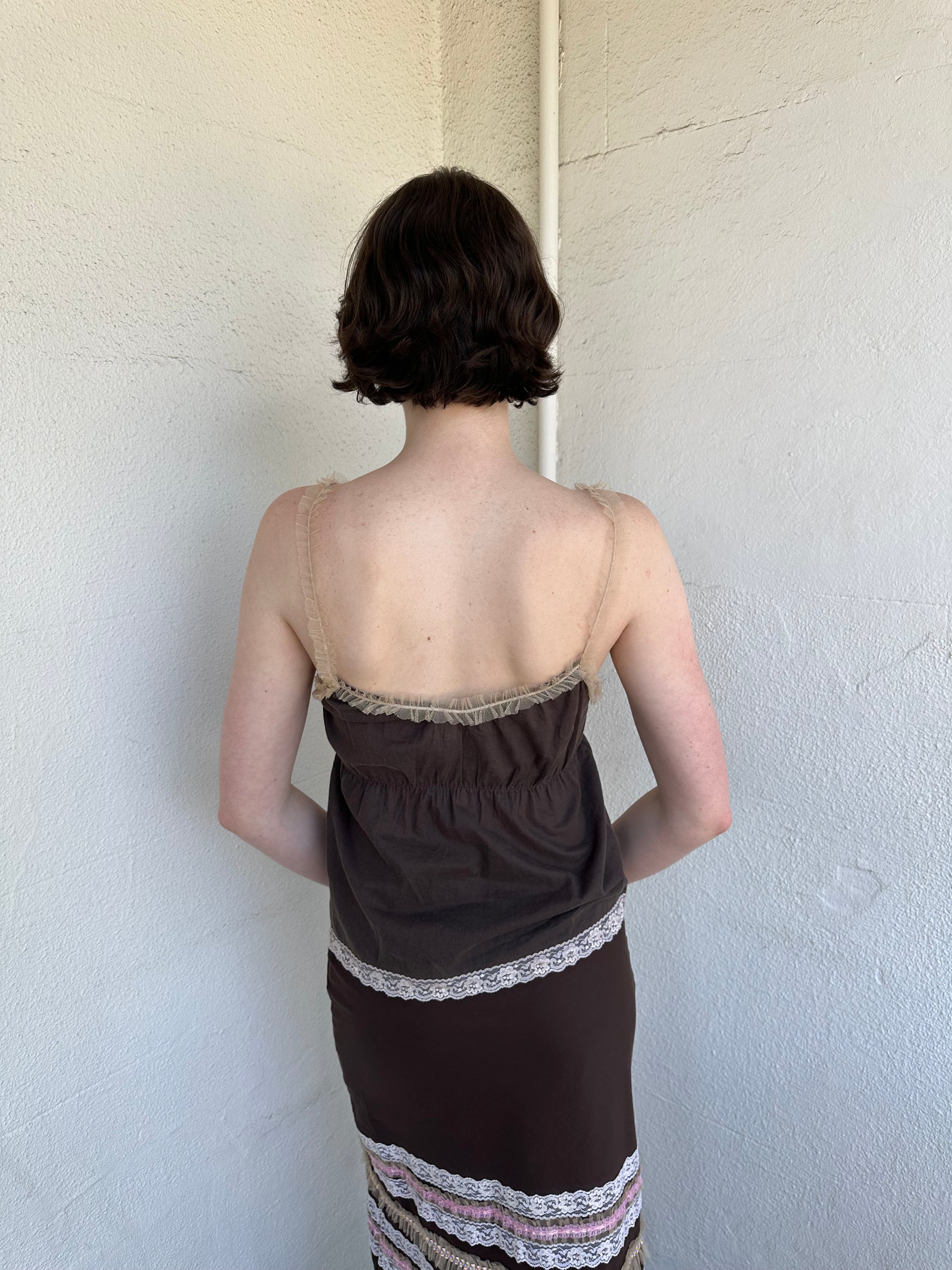 Woman Dressed in Y2K Brown and pink lace trim two piece set featuring a cami top and matching skirt detailed with cream lace and tulle trim throughout.