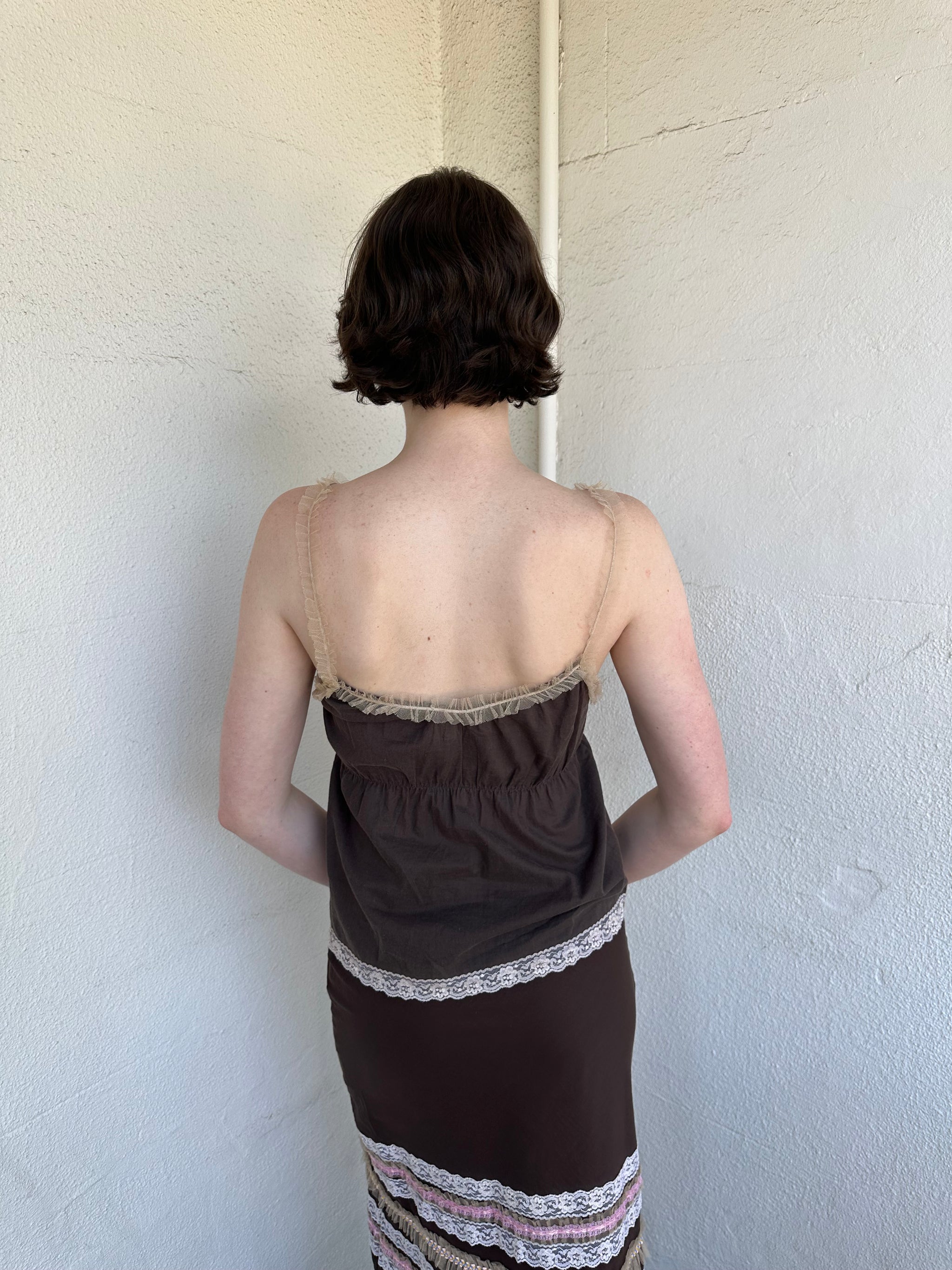 Woman Dressed in Y2K Brown and pink lace trim two piece set featuring a cami top and matching skirt detailed with cream lace and tulle trim throughout.