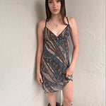 Woman wearing a Y2K 00s Brown and blue patterned midi dress with a soft paisley-floral print