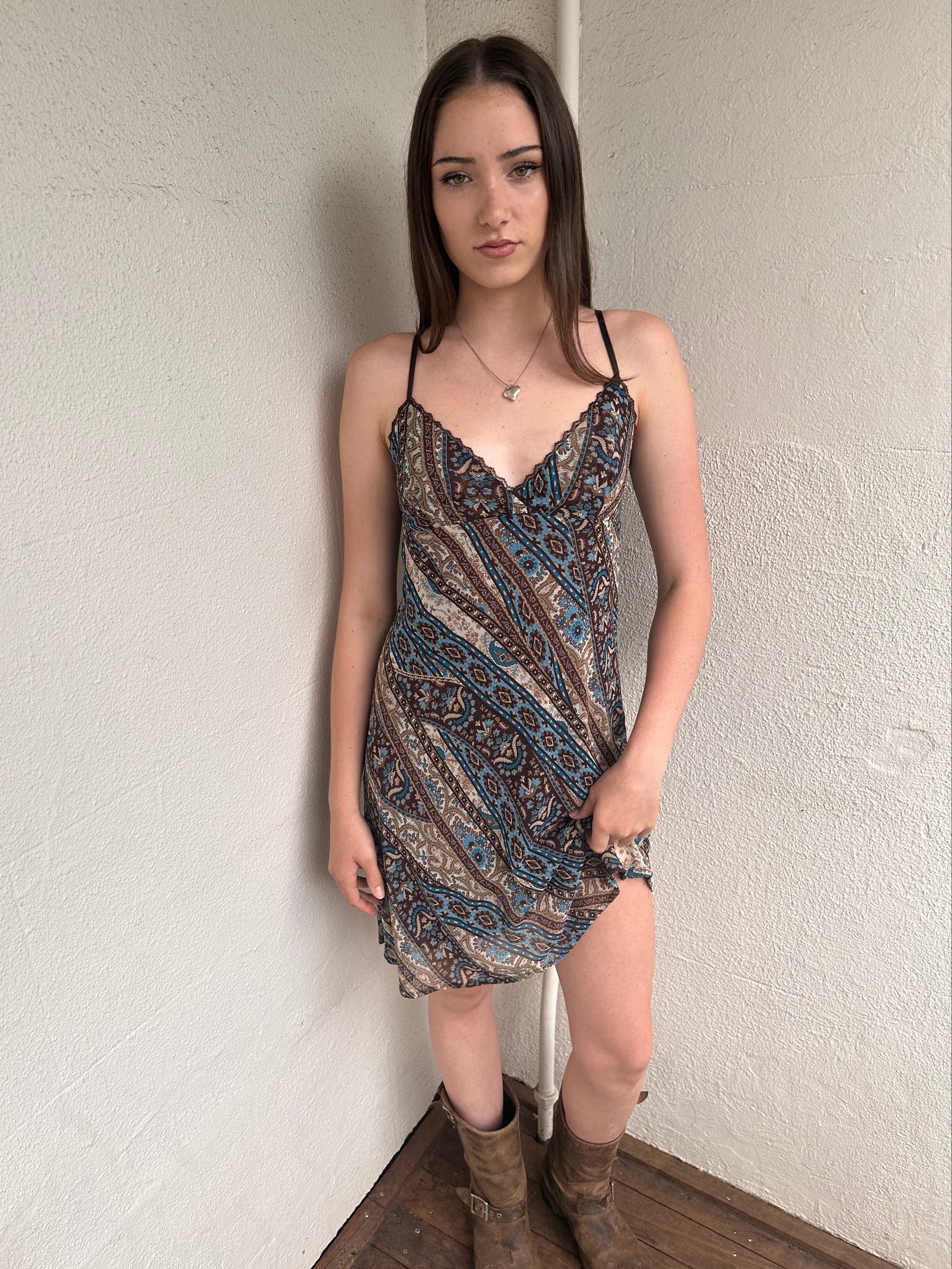Woman wearing a Y2K 00s Brown and blue patterned midi dress with a soft paisley-floral print