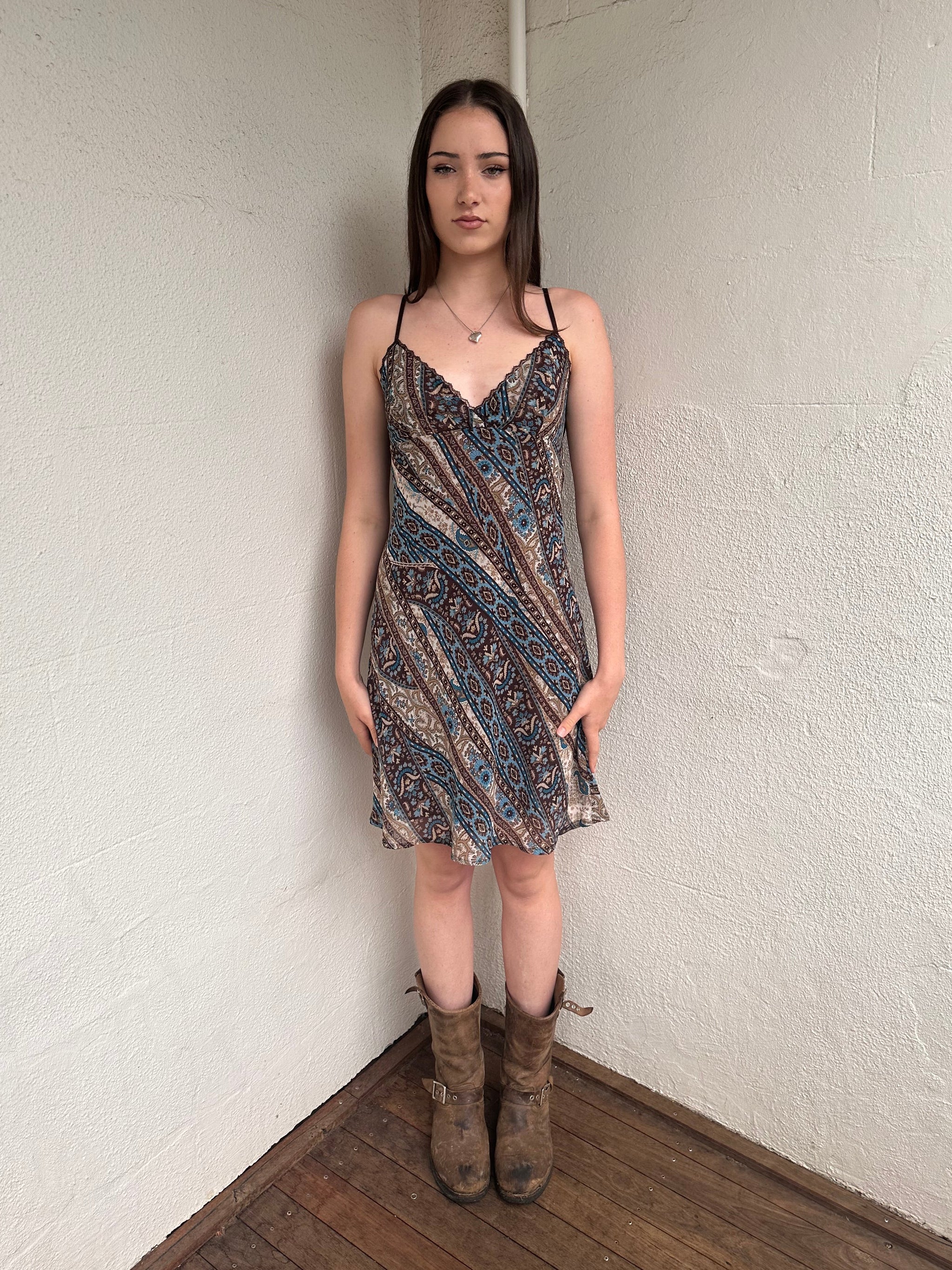 Woman wearing a Y2K 00s Brown and blue patterned midi dress with a soft paisley-floral print