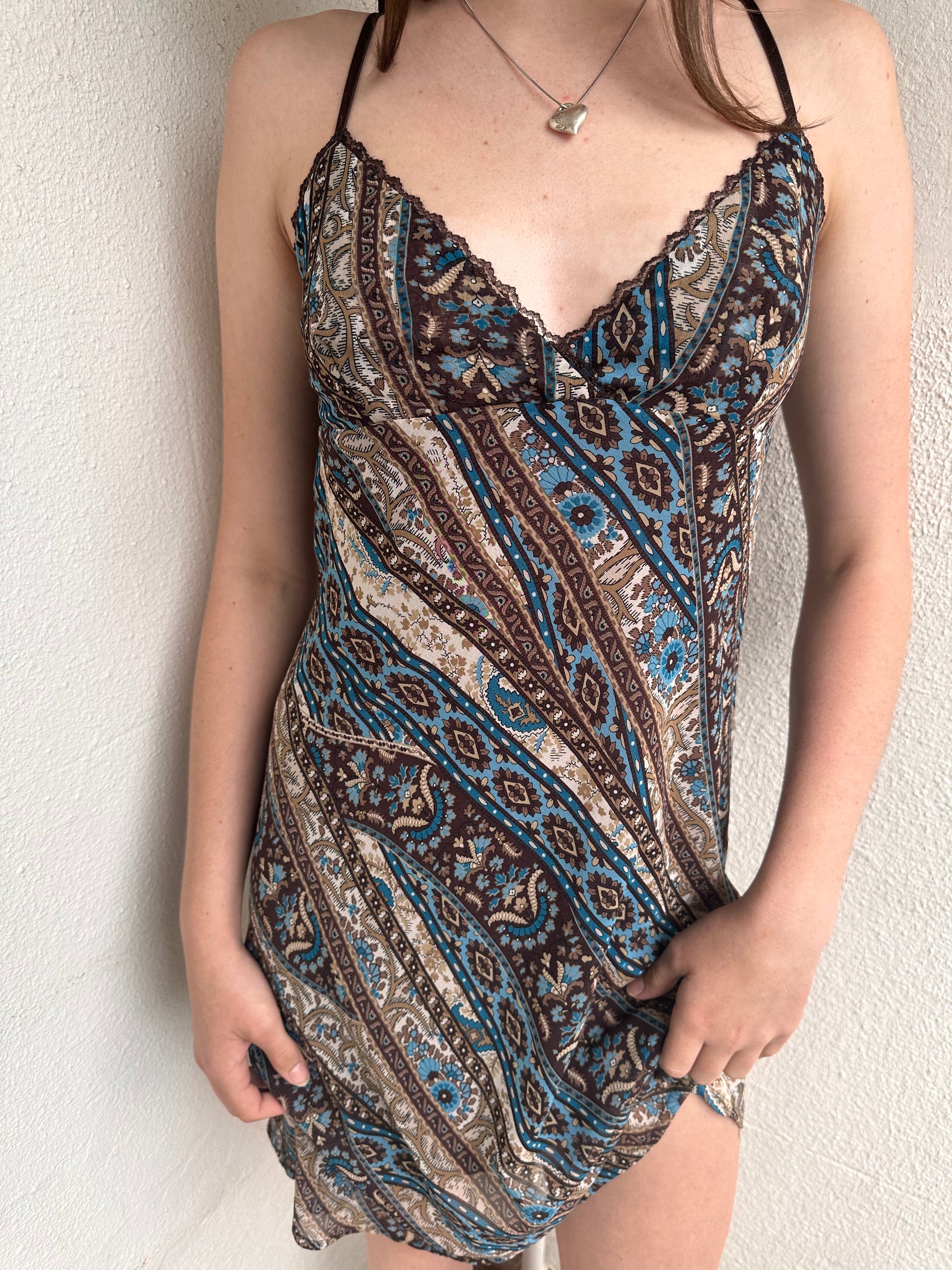 Woman wearing a Y2K 00s Brown and blue patterned midi dress with a soft paisley-floral print