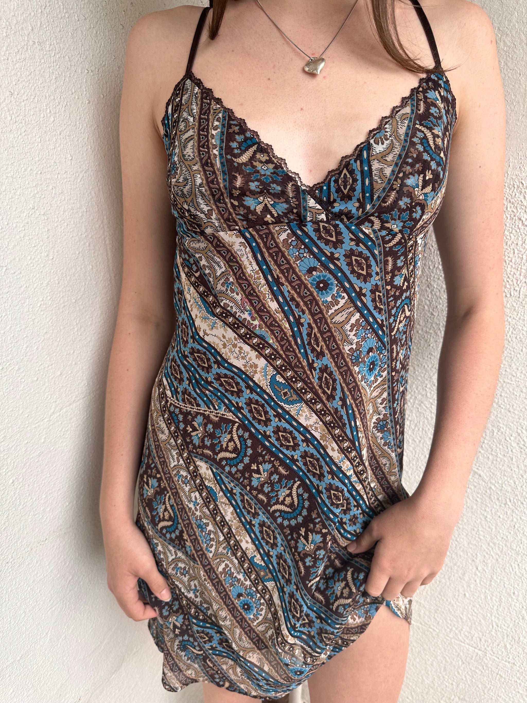 Woman wearing a Y2K 00s Brown and blue patterned midi dress with a soft paisley-floral print