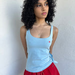 Women wearing a 00s Y2K Burberry baby blue tie cami from the 2000s featuring side tie and red embroidered logo. 