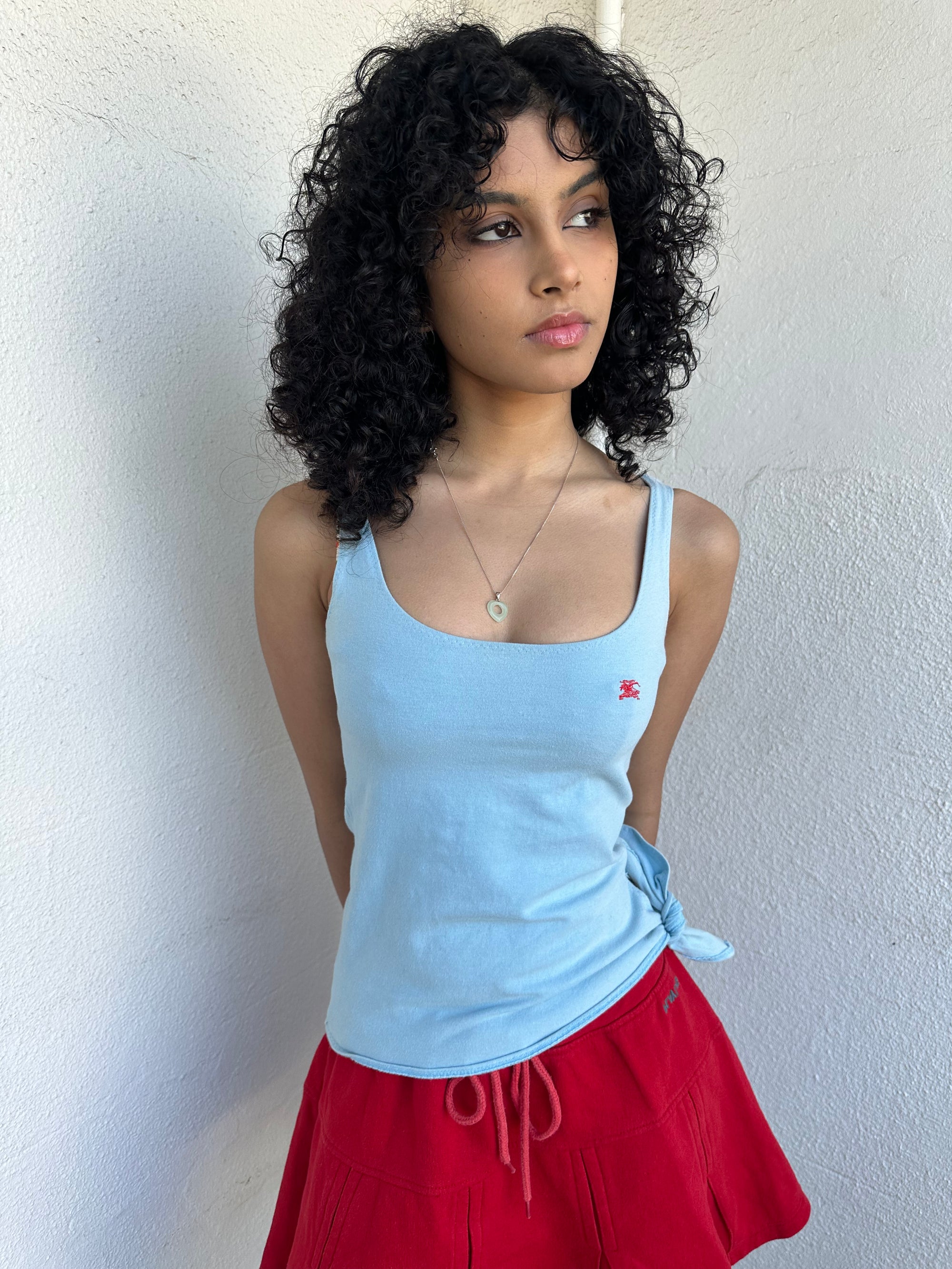 Women wearing a 00s Y2K Burberry baby blue tie cami from the 2000s featuring side tie and red embroidered logo. 
