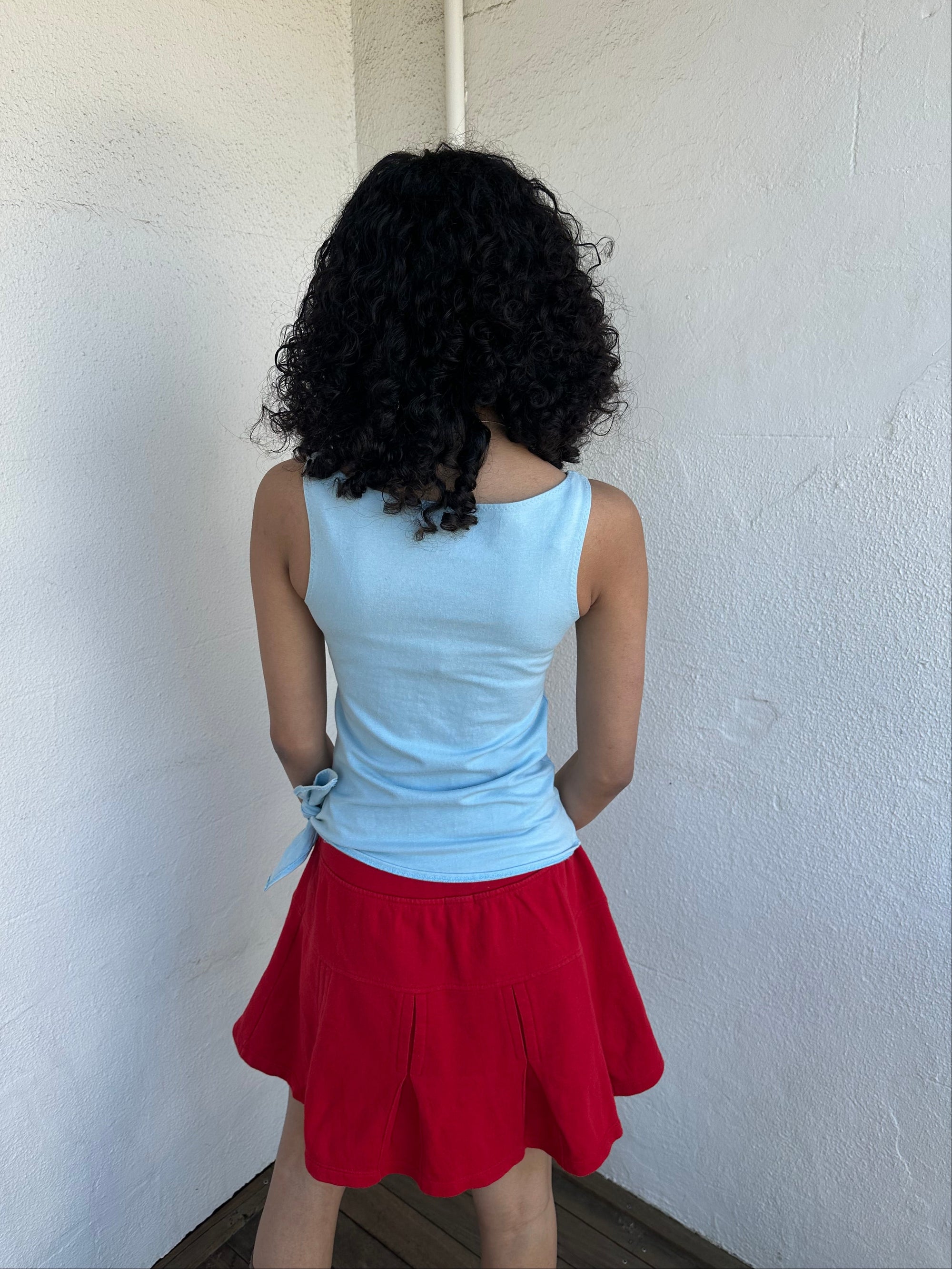 Women wearing a 00s Y2K Burberry baby blue tie cami from the 2000s featuring side tie and red embroidered logo. 