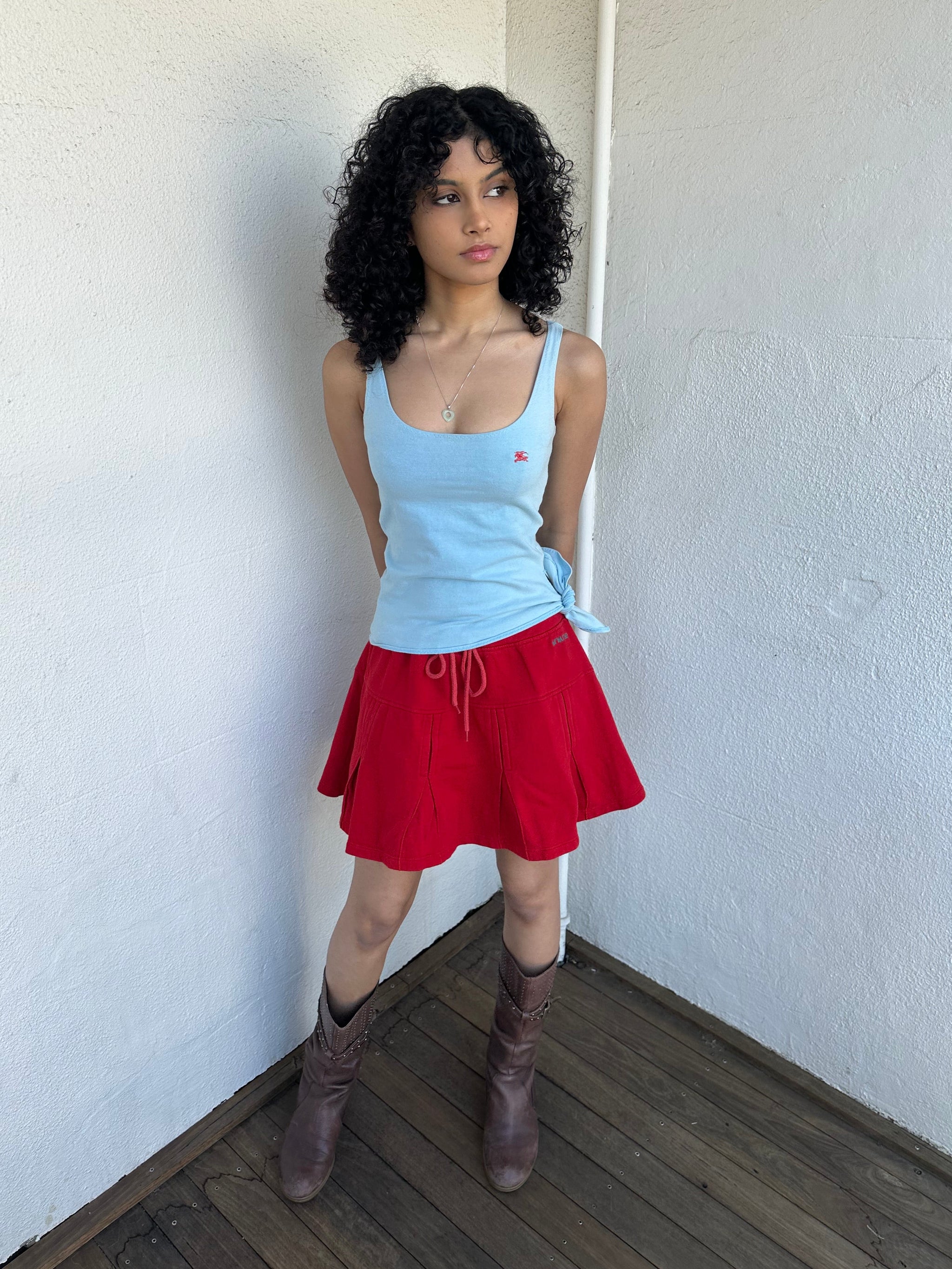 Women wearing a 00s Y2K Burberry baby blue tie cami from the 2000s featuring side tie and red embroidered logo. 
