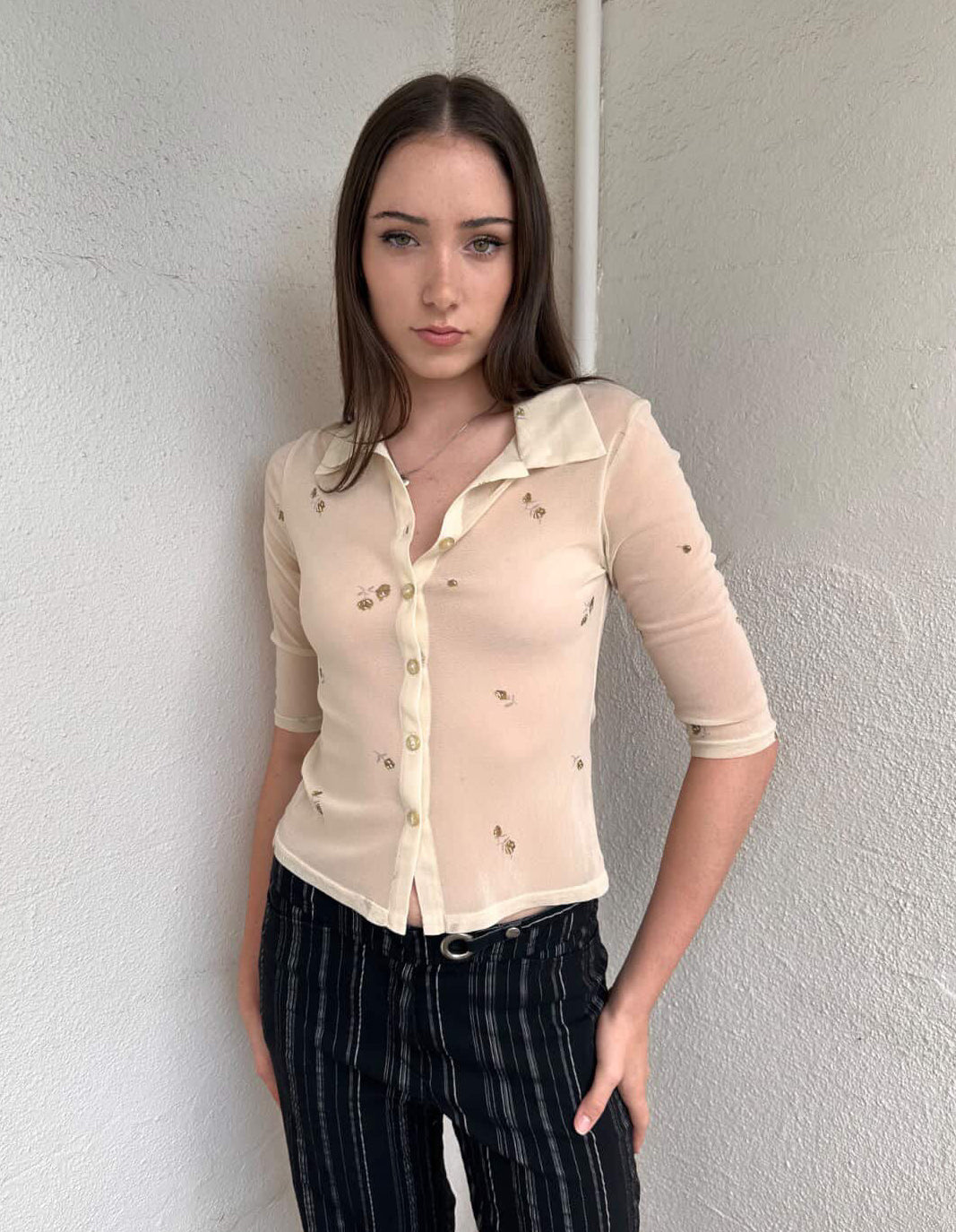 Women wearing a 00s Y2K Gorgeous 90s Cream floral mesh shirt with a cropped fit and 3/4 sleeves. 
